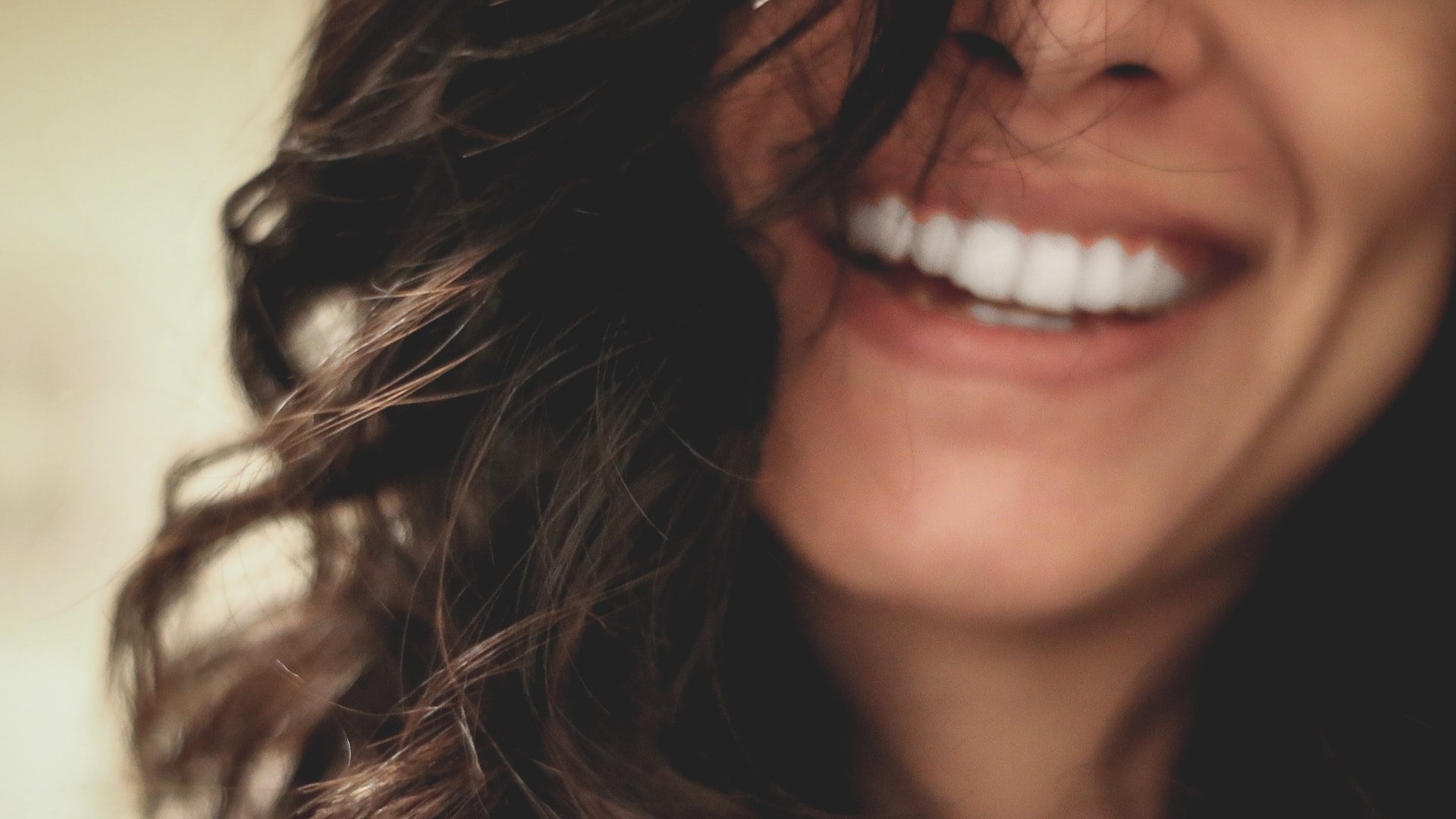 long black haired woman smiling close-up photography